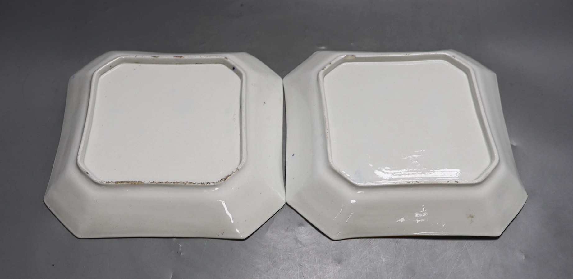 A pair of Coalport ground blue and gilt porcelain square dishes, c.1815-20, with floral panelled decoration. 22cm wide